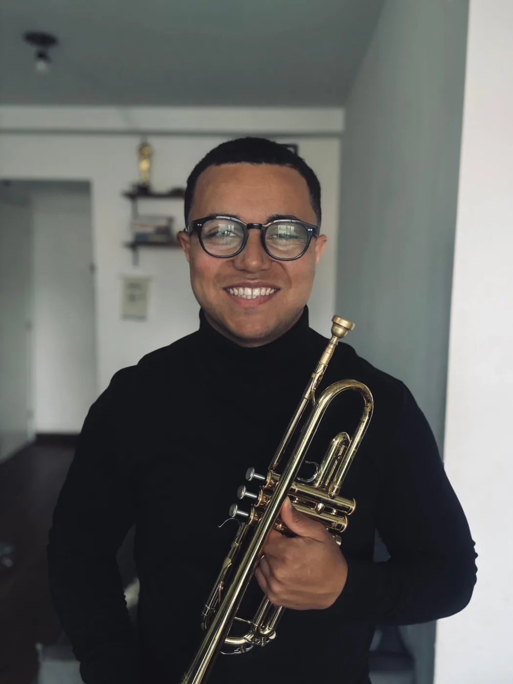 Asaph Bispo sorrindo, segurando o trompete
